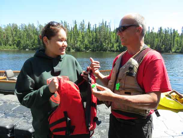 Junior Canadian Ranger Laurinda Miles of Fort Severn First Nation receives a life jacket to take home with her from Gordon Giesbrecht. Credit - Sergeant Peter Moon, Canadian Rangers