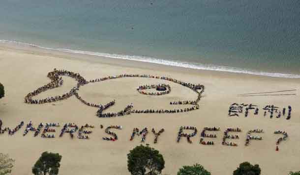 A view of over 800 schoolchildren, teachers and volunteers forming the shape of a fish with a sad expression, alongside Chinese characters that read "refrain", at Repulse Bay in Hong Kong, April 23, 2015. The event was in honour of Kids Ocean Day, to send a global message to stop consuming reef fish in order to protect the Earth's coral reefs. REUTERS/Bobby Yip