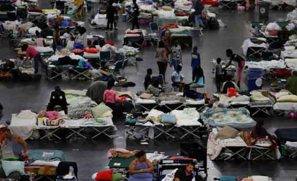 Evacuees affected by Tropical Storm Harvey take shelter at the George R. Brown Convention Center in downtown Houston, Texas, U.S. August 31, 2017. REUTERS/Carlos Barria