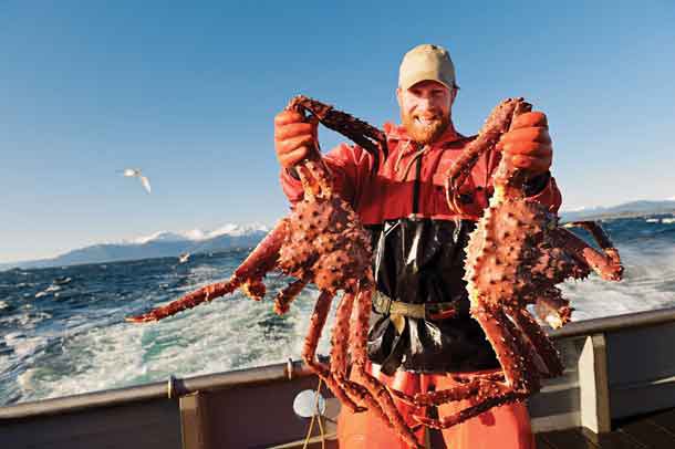 Alaska fisherman Kevin S. shows off his prized catch of wild, sustainable Alaska king crab, now in season along with Alaska snow and Dungeness crab. 