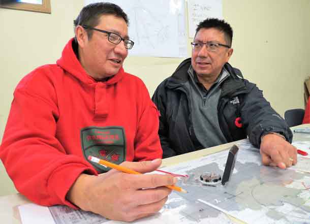 Ranger Jeffery Fiddler of Muskrat Dam, left, gives his brother, Grand Chief Alvin Fiddler of Nishnawbe Aski Nation, a briefing during a search and rescue exercise in Sachigo Lake  in 2015.
