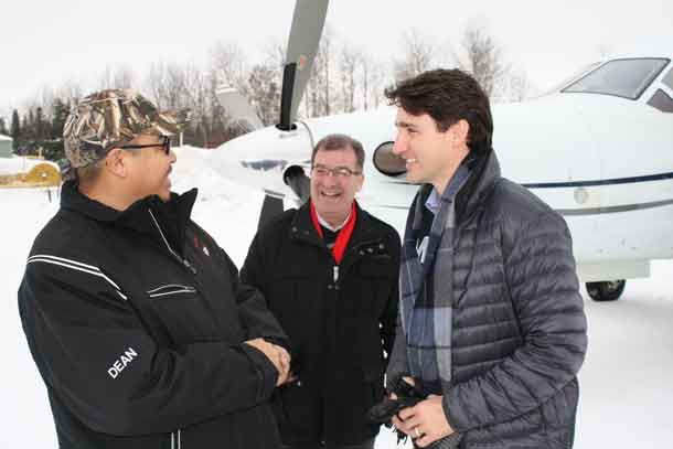 Arriving in Pikangikum, Chief Dean greets Prime Minister Trudeau and Kenora MP Bob Nault