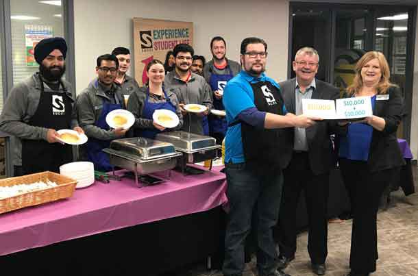 SUCCI and Confederation College are serving up to $30,000 in support of students to kick off this year’s Stock the Bank campaign. Pictured in back are the SUCCI Board and volunteers who made pancakes and bacon to help launch the campaign. In front are (from left), SUCCI Administrator of Wellness and Diversity Thomas McDonald, Confederation College President Jim Madder and Confederation College Manager of Advancement and Alumni Services Dana Levanto.