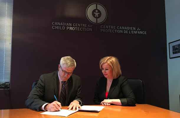 Commissioner Vince Hawkes, Ontario Provincial Police and Lianna McDonald, Executive Director for the Canadian Centre for Child Protection sign an important agreement to enhance the safety of children and youth in Ontario. (Ontario Provincial Police)