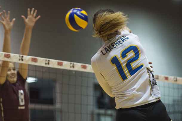 LEAH MOUSSEAU #12 smashes a spike into the opposition's court - photo by Richard Zazulak