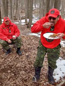 Corporal Gilbert Spence, right, eats haggis, watched by Master Corporal Joe Lazarus, seated.