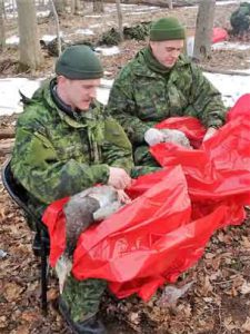 Corporal Adam Sharp and Master Corporal Marcus Dowling of the Toronto Scottish Regiment learn how to pluck geese. Photo Credit: Captain Ann Lockhart