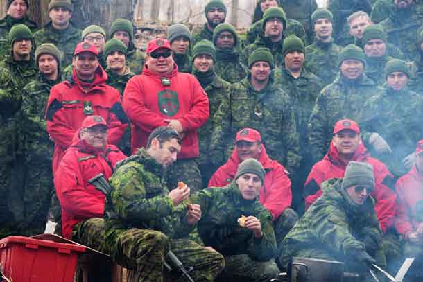 Canadian Rangers, in their distinctive hoodies, with some of the 70 soldiers they trained in winter survival skills.
