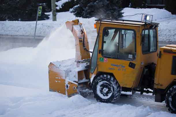City of Thunder Bay using a snowblower to clear sidewalks of the last storm