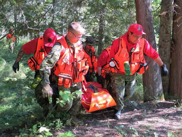 Canadian Rangers carry a "victim" on a stretcher during a search and rescue training exercise.