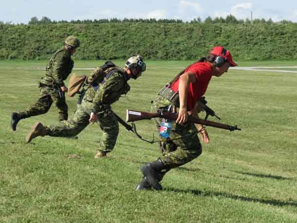 Master Corporal Donny Sutherland, right, runs from one shooting position to another in a competition.