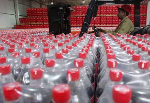 ARCHIVE PHOTO: A worker passes by bottles of Coca-Cola at the newly inaugurated bottling plant in Kabul, Afghanistan September 10, 2006. REUTERS/Ahmad Masood