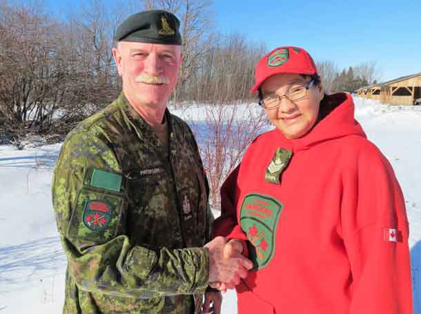Canadian Rangers waiting for a training class photograph to be taken applaud Sergeant Linda Kamenawatamin, left, on learning she is to receive the Order of Military Merit.