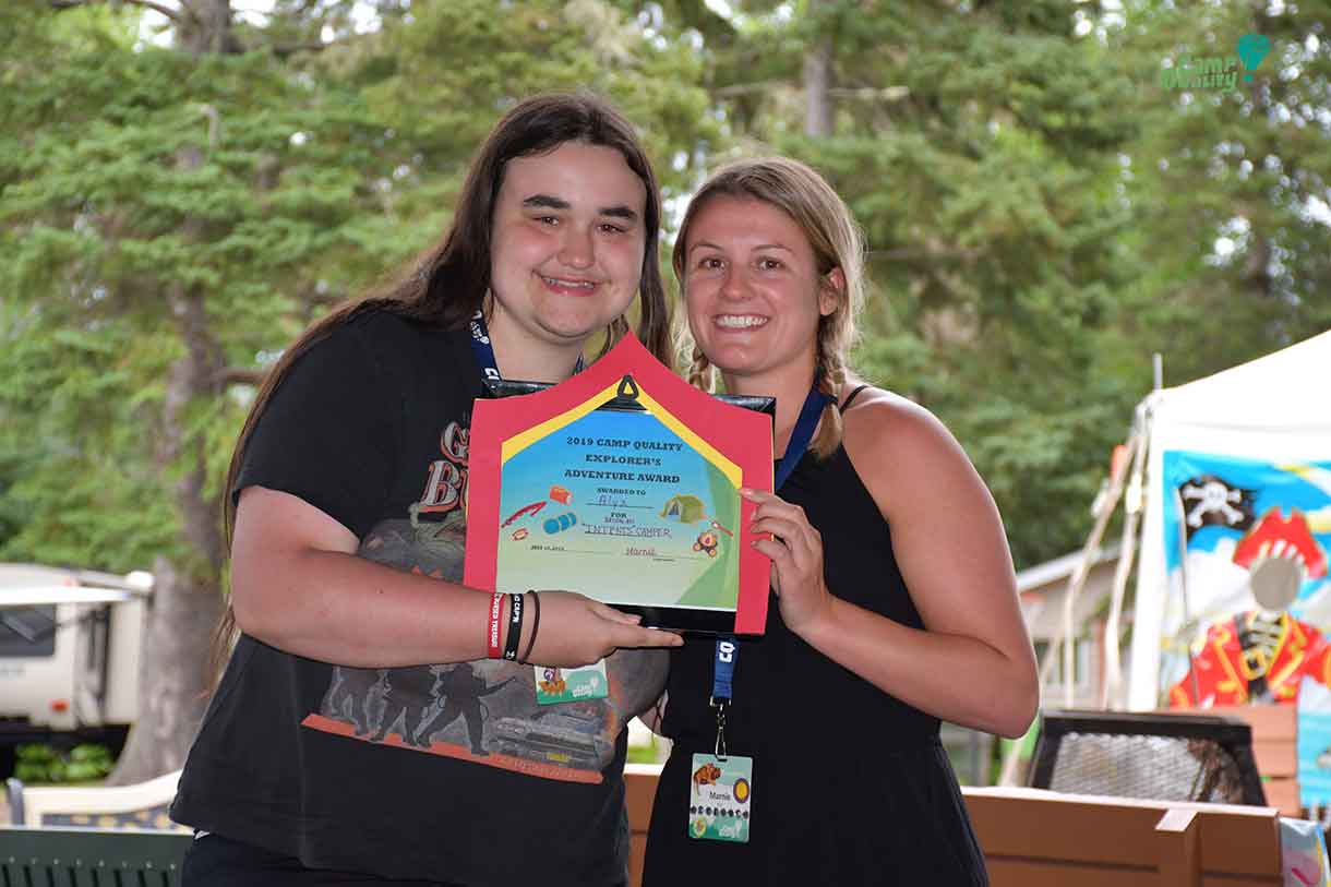 Camper Alyx (left) was presented with the “Intents” award from Companion Marnie for camping out during teens in tents night.