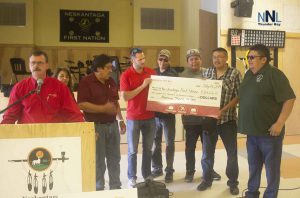 North Star Air Vice President Tom Meilleur and Neskantaga First Nation Chief Chris Moonias and members of his Council accept revenue sharing cheque