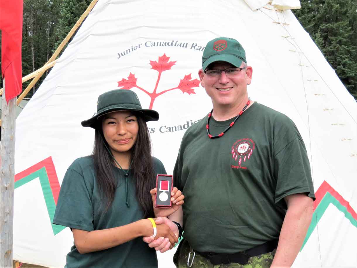 Junior Canadian Ranger Chasity Koosees of Kashechewan receives the Order of St.George Medal from from Lieutenant-Colonel Matthew Richardson.