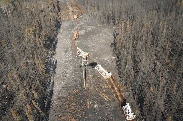 Hydro One crews work to rebuild 80 transmission structures damaged by a forest fire in northwest Ontario