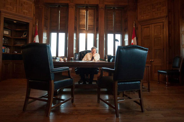 Prime Minister Harper in what could be a telling image of how it is lonely at the top