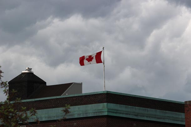 Canadian Flag stands strong on Government Building in downtown southcore