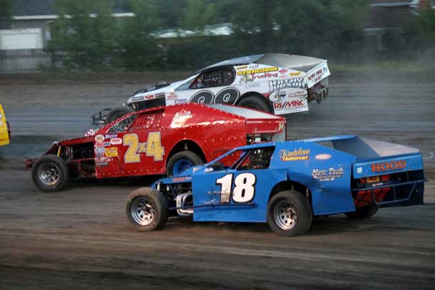 #18 Bill Reimer, #2X4 Ken Perry, and #99 Brody Strachan  battled it out during the WISSOTA Midwest Modified feature which had  several three and four wide battles throughout the 20 lap feature.