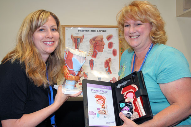 Allyson McDonald (left) and Laurie Ryan-Cooper show the learning models that help people with swallowing difficulties visualize the disorder, and how to avoid choking and other risks. The models were purchased thanks to a Family CARE Grant from the Volunteer Association/Thunder Bay Regional Health Sciences Foundation.