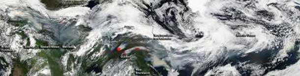 NASA's Aqua satellite captured multiple images of fire and smoke from Canadian wildfires on July 4, 2013. The images were stitched together to form a visual quilt.