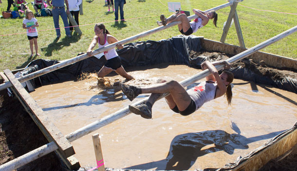 Sliding down the Grease Pole nearing the Finish Line.. Dirty Girls having fun!