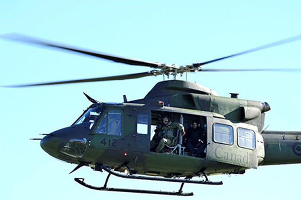 A Griffon helicopter takes off containing personel from Canadian Forces and RCMP during operation OSABOT 