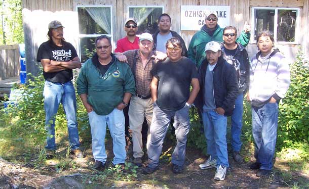 Back Row - left to right: Robert Boyce, Faron Shawinimash, Terry Okeese Front Row - left to right:  David Waswa, Lewis Nate, Rugged Dude, David Boyce Sr., Leslie Atlookan, Terrance Keeskitay and George Waswa