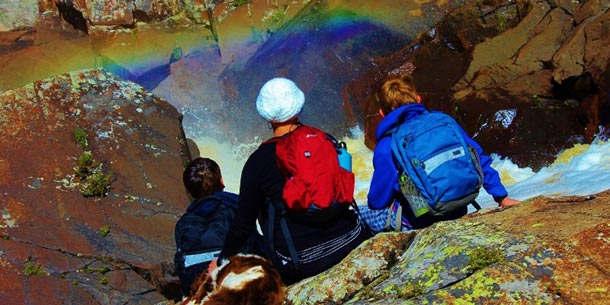 Taking time to enjoy a rainbow over the rapids. Photo by Rike Burkhardt