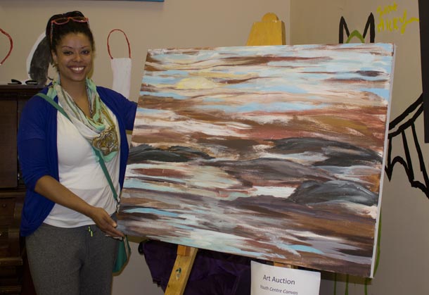 Youth Centre President Colleen Peters poses with one of the amazing art pieces at Youth Tbay