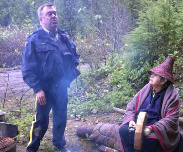 Xwu'p'a'lich Shishalh Elder sits at Sacred Fire being asked to leave by RCMP