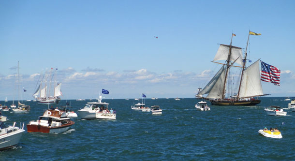 The 157-foot topsail schooner Pride of Baltimore II surrounded by spectator boats during the re-enactment of the Battle of Lake Erie where the tall ship portrayed the US Brig Caledonia. (Photo courtesy of Tall Ships America)