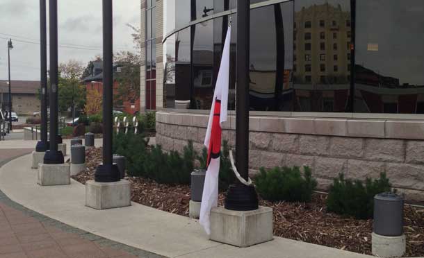 Poppy Flag raised at City Hall to remember and remind residents to wear a poppy.