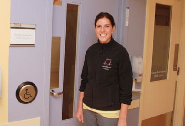 ICU nurse Kayley Heppler shows the new automatic door opener that allows family and visitors with mobility challenges to enter and exit the ICU more easily.  Funding for the door opener was provided thanks to a Volunteer Association/Thunder Bay Regional Health Sciences Foundation Family CARE Grant.