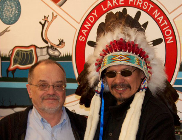 Chief Bart Meekis of Sandy Lake First Nation (right) and Blaine Webster of Goldeye Explorations Limited (left) with signed Exploration Agreement.