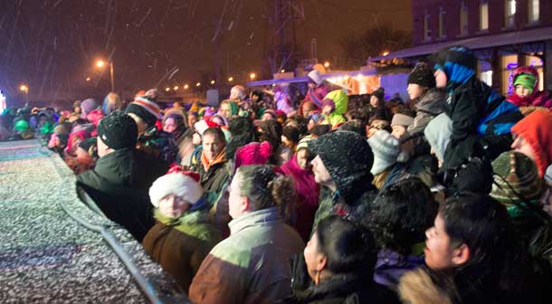 A huge crowd of enthusiastic people crowd the stage at the CP Holiday Train.