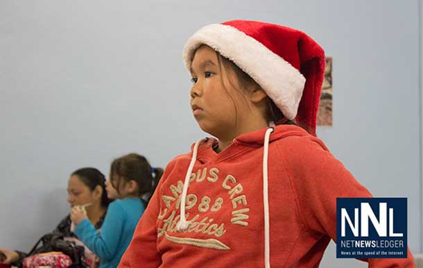 Waiting patiently for Santa Claus, this young lady was enjoying time with family and friends.