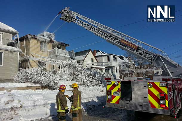 Thunder Bay Fire Rescue Crews on scene with aerial ladder to ensure fire is out.