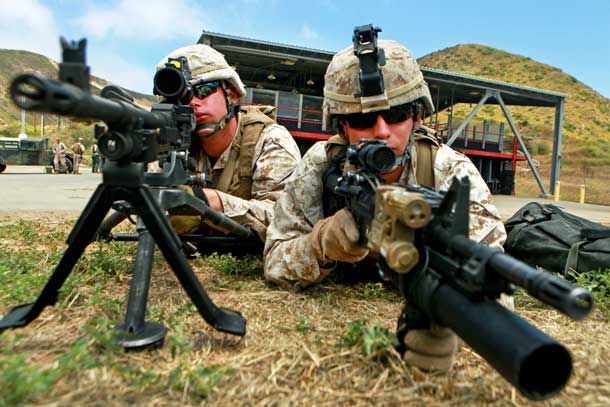 Marine Corps Lance Cpls. Benjamin V. Stout assists Lance Cpl. Josh M. Tasior as they hold security on the outer cordon of a target site during a Maritime Raid Force training course on Camp Pendleton, Calif., Jun. 15, 2011. Stout and Tasior are machine gunners assigned to the 11th Marine Expeditionary Unit's maritime raid force. U.S. Marine Corps photo by Cpl. Chad J. Pulliam