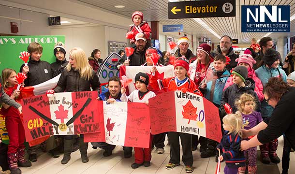 The crowd of all ages is very excited to see their hockey hero at the airport.