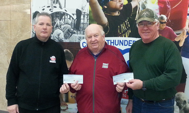 Larry Hebert, centre, President of the Thunder Bay International Baseball Association presented cheques to Ron Kowalchuk, right, President, Thunder Bay Umpires Association and Norm Randle, left, President of District 3 Little League