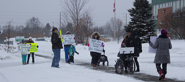 Signs seeking to share the message were carried to try  to get School Trustees to understand the impact of the actions of administrators.