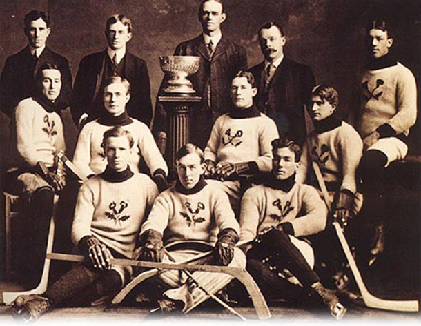 The Kenora Thistles’ Stanley Cup championship photograph. Back row: team president Lowry Johnson, Russell Phillips, coach and trainer J. A. Link, and team manager Red Hudson. Middle row: Roxy Beaudro, Tom Hooper, Tommy Phillips, Billy McGimsie, and Joe Hall. Front row: Si Griffis, Eddie Giroux, and Art Ross.