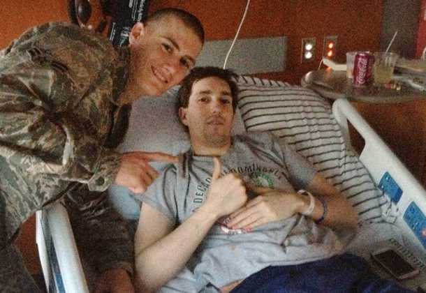 Air Force Airman 1st Class Alan Bauman visits his brother, Jeff Bauman, in a Boston hospital. Jeff lost both of his legs from the explosion near the finish line at the Boston Marathon on April 15, 2013