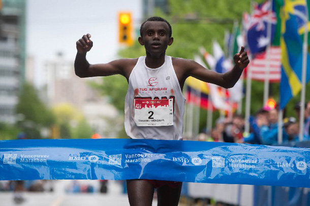 Under cloudy and wet conditions, the 2014 BMO Vancouver Marathon on Sunday, May 4, 2014, was won by Berhanu Mekonnen of Ethiopia with a time of 2:21:08 for male runners. (Darryl Dyck/The Canadian Press Images/BMO Financial Group)