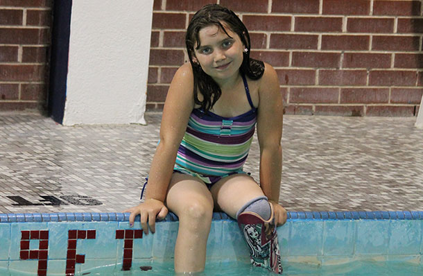 Addisyn in the pool with her new swim leg.