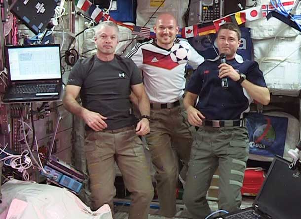 (From left) Expedition 40 Commander Steve Swanson and Flight Engineers Alexander Gerst and Reid Wiseman wish soccer fans and the World Cup 2014 "peaceful games." Image Credit:  NASA TV