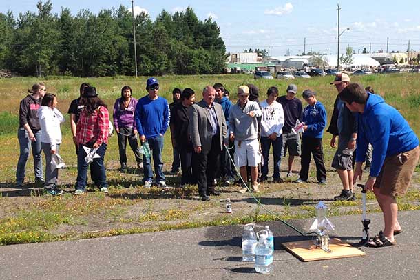 College President Jim Madder Gets a Lesson in How to Launch a Bottle Rocket from the Camp Participants