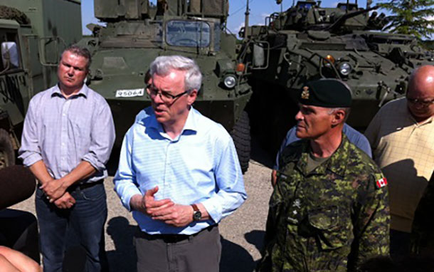 Premier Greg Selinger and Brigadier-General Christian Juneau join rural officials at Southport Airport near Portage before touring flood zones